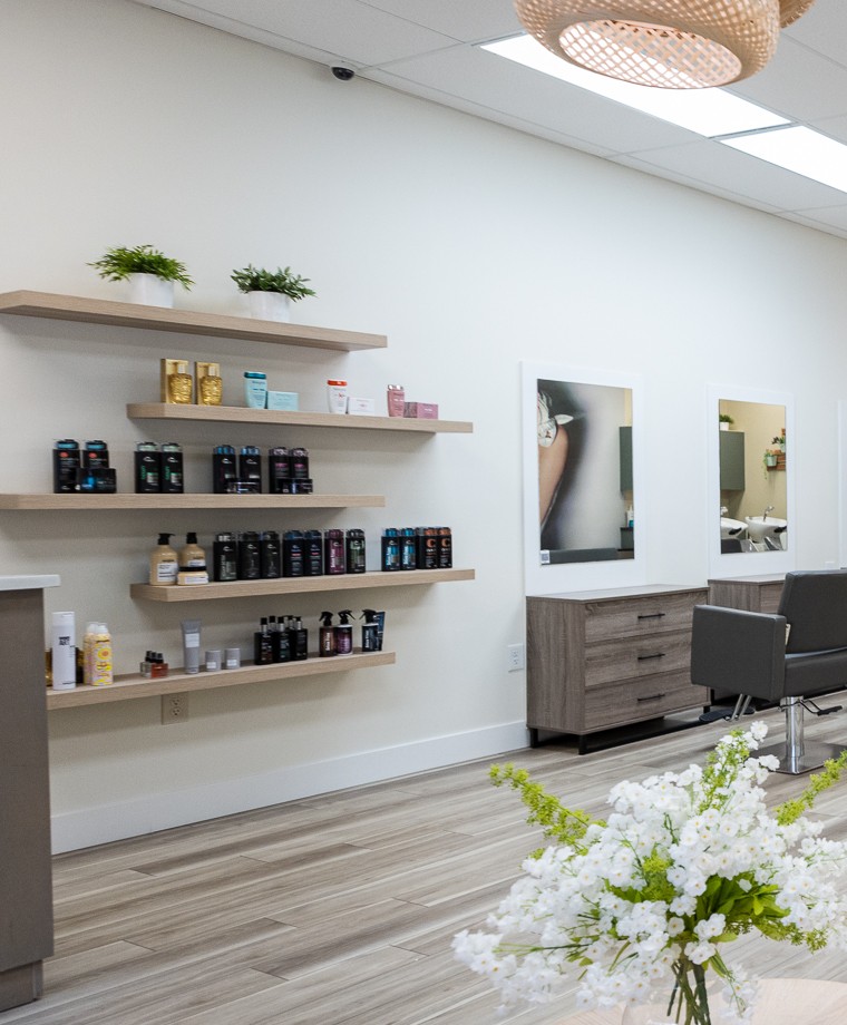 Retail shelves of hair and color products at Babelle Salon & Spa